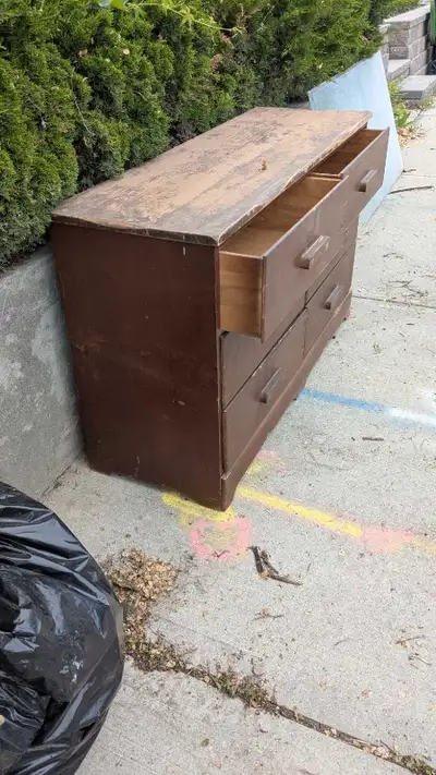 All wood dresser that needs some paint to dress it up otherwise still good. It's in the street for t...