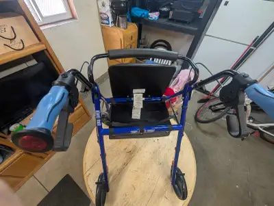 Great Hugo Elite rollator walker. Has a comfy seat, backrest, locking hand brakes, and a handy saddl...