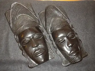 two tribal hand carved African wooden hanging masks. 12-1/2' x 6, View more
