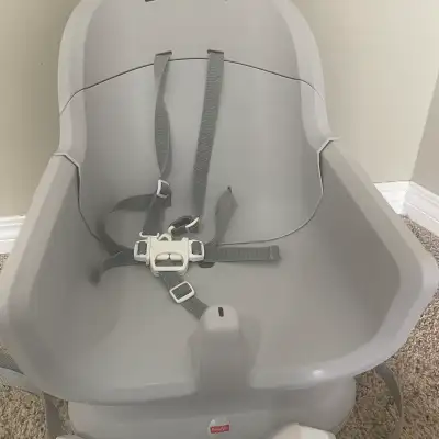 This is a used Fisher-Price baby high chair designed to bring your little one up to the family table...