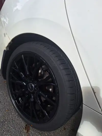Four gloss black rims no tires used in a good condition