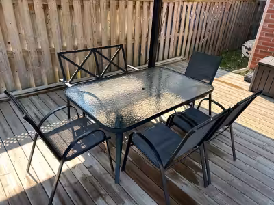 Black frame, glass table, 4 chairs and 1 bench. Seating for 6. Very good condition.