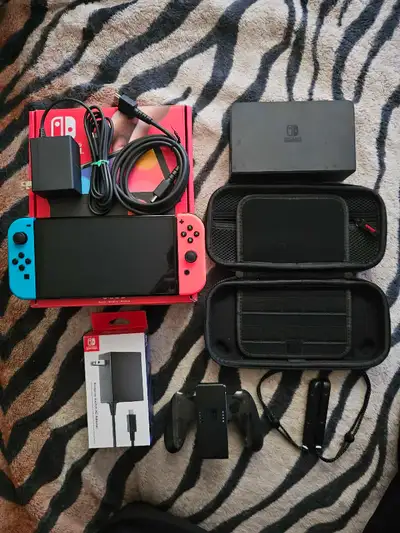 New condition oled nintendo switch. Comes with original packaging, dock, joycon controller and caps,...