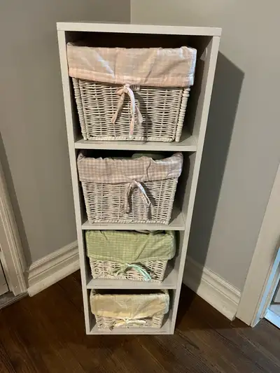 34 1/4” high; 10 1/4” deep; 11” wide. 4 white wicker baskets lined with checked pastel coloured fabr...