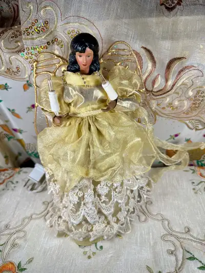 The 10 inches tall angel is holding 2 candles that you plug in.