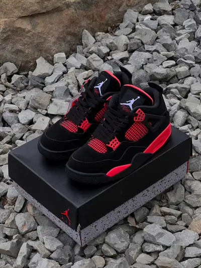 Up for grabs are these Jordan 4 Red Thunder sneakers . These shoes feature a striking black and red...