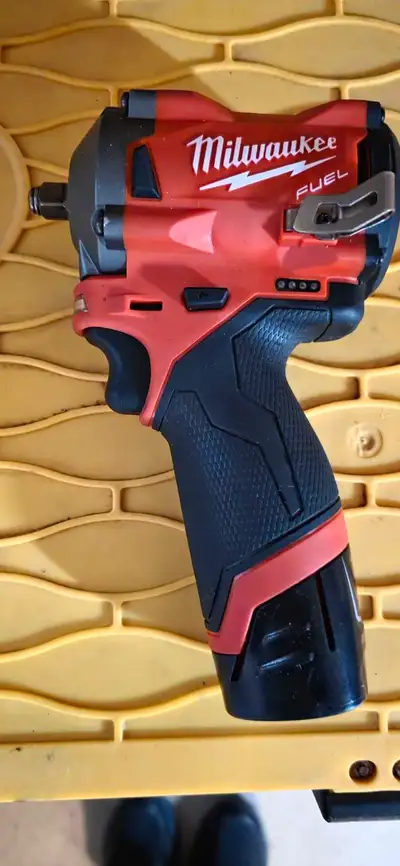 This is a used Milwaukee M12 FUEL Stubby 3/8" Impact Wrench (2551-20) that delivers impressive power...