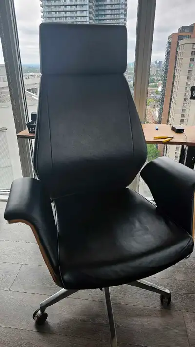 Executive leather and wood chair. Un known designer. Cracked wood on the sides but the chair is stru...