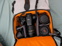 Sony A65 DSLR Camera with three lenses, SD card, and camera bag