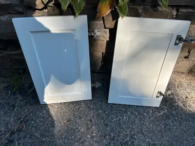 I am selling a pair of used cabinet doors, each measuring approximately 13 inches in width and 24 in...