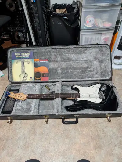 Squier Bullet Stratocaster guitar Two guitar books Slide Whammy Bar Footrest 2 picks Hardcase About...