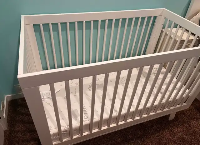 White wooden crib with adjustable levels  Mattress included