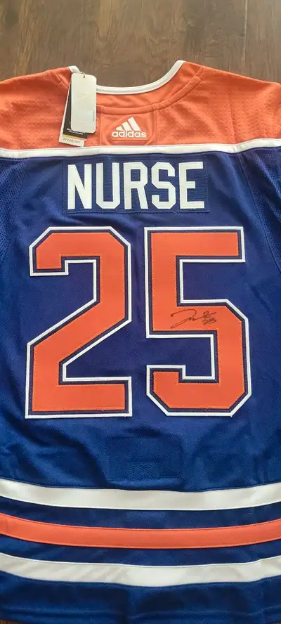 Brand new with tags, Adidas, Size 52 (medium to large) Jersey with fight strap. Signed by Darnell Nu...