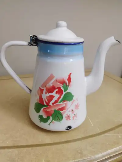 Add a touch of vintage charm to your kitchen with this beautiful floral enamel teapot. This is a pre...
