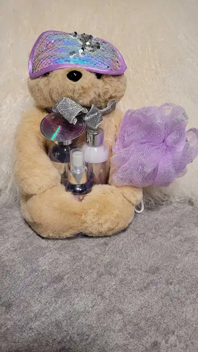 New Bath gift set includes a plush teddy bear wearing a sequined eye mask and holding a collection o...