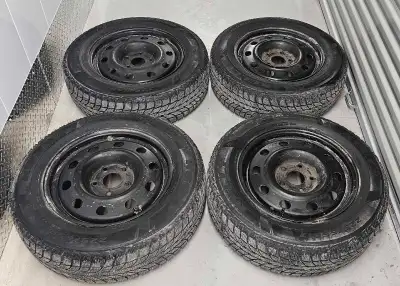 Set of 4 black steel rims with winter tires, good condition lots of tread left, bolt pattern 5×127 w...