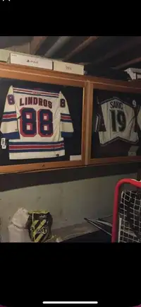 Signed Joe Sakic and Eric Lindros jerseys in oak case