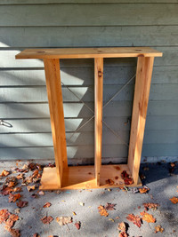 Rough wood small shelving unit with metal bracing.