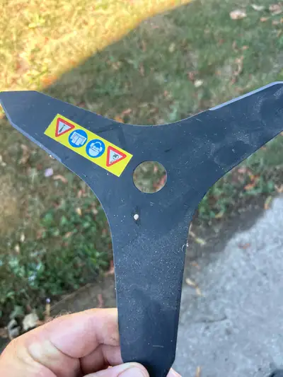 This is a used brush cutter blade in good condition. This metal three-blade brush cutter blade is pe...
