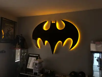 Very large bat logo made out of plexiglass and painted with glossy black paint. Tucked inside is a y...