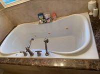 Jacuzzi tub with granite surround and faucets