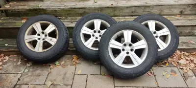 Four 16-inch wheels with 215/65R16 Goodyear UltraGrip winter tires. Good tread remaining. Tires are...