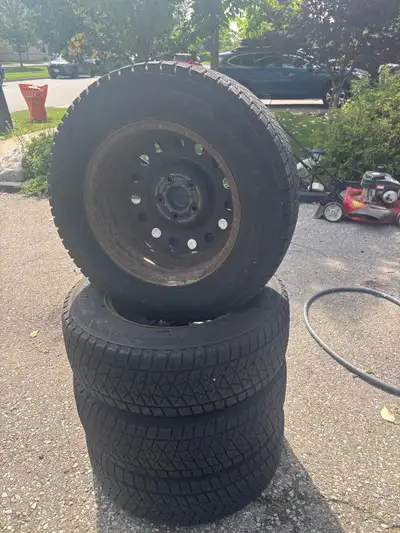 Set of 4 winter tires for sale. All tires on rims with hub covers. Bridgestone Blizzaks 215/70R16. D...