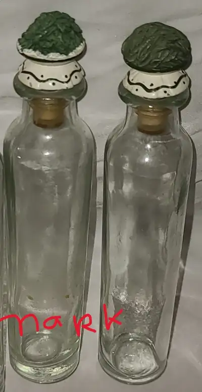 THREE MARKED GLASS BOTTLES, RAISED DECORATIONS OF VEGETABLES, View more