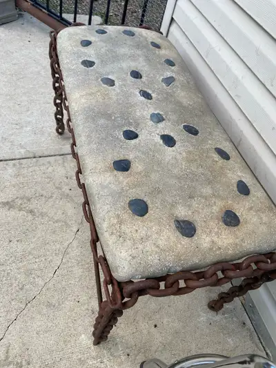 This is a unique, artisan-made bench featuring a welded chain frame and a concrete top with decorati...