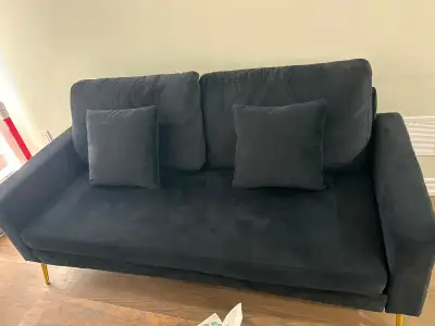 Black velvet love-seat with a grid-tufted armrest and gold legs., View more