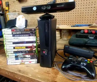 Microsoft xBox 360 slim console with one controller, Kinetic bar, and 14 games. Cash only. Pickup on...