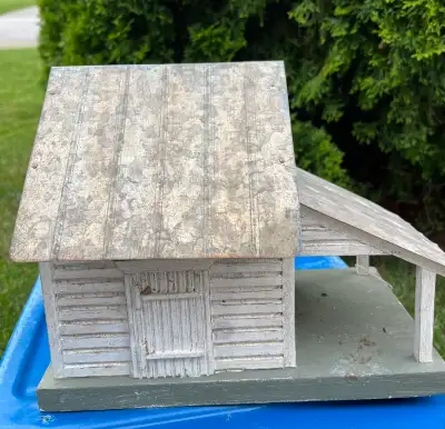 Charming ornamental garden cottage with rustic wood siding and a durable corrugated metal roof. This...