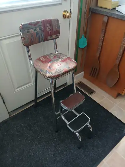 This is a vintage chrome step stool chair with a padded seat and backrest, perfect for adding a touc...