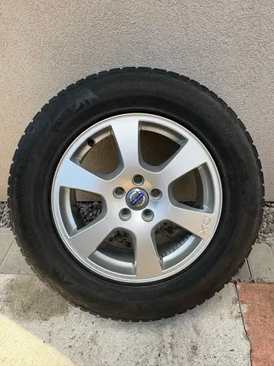 Set of 4 winter tires on alloy rims for Volvo XC60/XC70. Tires have 2–3 seasons of tread remaining,...