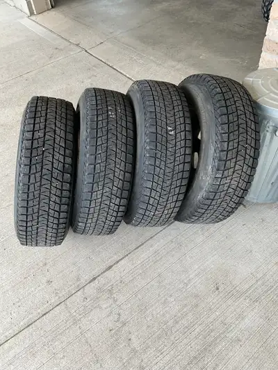 Four 235/75R17 Blizzak winter tires on steel rims. Wheels are off a GMC Acadia, 6x132 bolt pattern,...