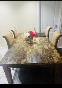 Family dinning table set along with four chairs.