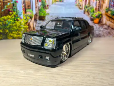 This JADA TOYS Dub City Big Ballers 1:18 scale die-cast model of the Cadillac Escalade EXT is a rare...