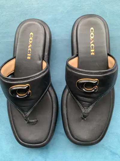 Selling a pair of Coach black leather thong sandals in size 8. These sandals feature the classic Coa...