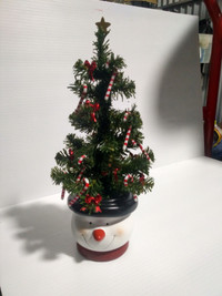 Christmas: Tiny spruce tree in ceramic snowman. with decor