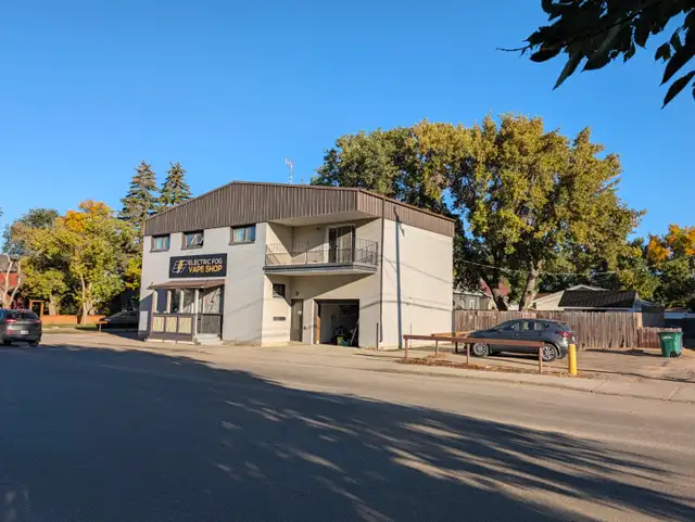 Main floor retail plus 4 BR apartment, garage and basement