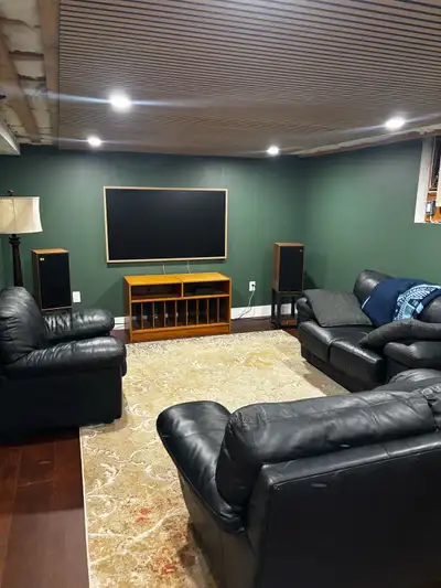 Three pieces of black leather living room furniture. Two love seats and an oversized chair. No rips...
