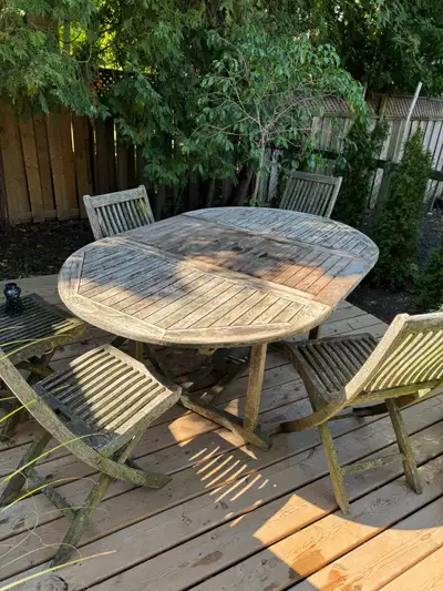 7 piece solid teak table expands to 71 inches and is 47 inches wide. Includes 4 chairs and two side...