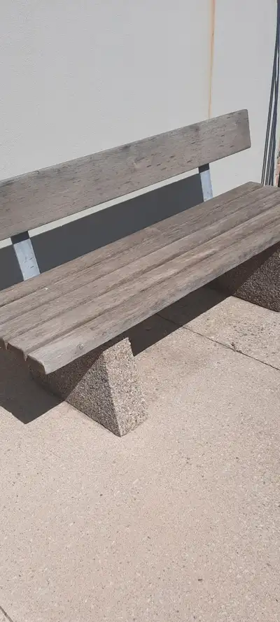 Concrete bench with backrest very old and in very good condition except the small part of the concre...