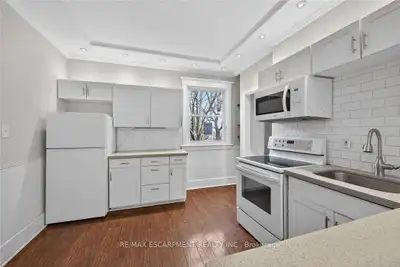 full kitchen- quartz counters, shaker cabinets- white , View more