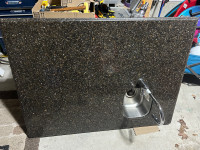Stone island countertop with sink and faucet