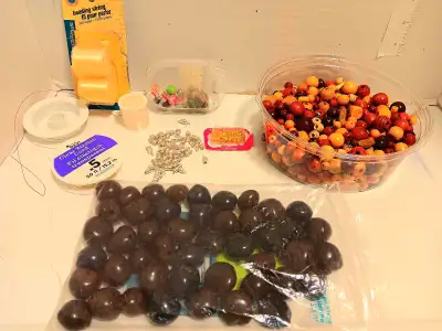 Selling a collection of beading supplies, metal buckle lock connectors, and gold earring backs. Incl...