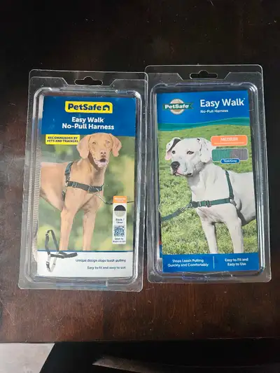 Two medium dog harnesses, new, tried on and too big for my dogs. One black, one teal. No pull martin...