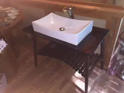 Unique vanity by Medonte Wood Works. Glass top. Vessel sink, Waterfall faucet,Shelf with two baskets...