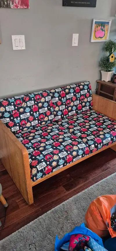 This wood couch features a unique and colourful monster-themed pattern, making it a fun addition to...