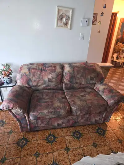 This comfortable sofa and loveseat set.upholstery with a multi-toned patterned fabric perfect for an...